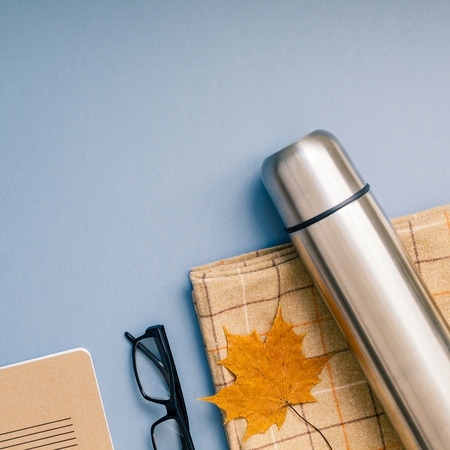 Creative Top view flat lay outdoors trip composition. blanket autumn leaf grey blue background copy space. Square Template weekend outing picnic nature tourism recreationの写真素材