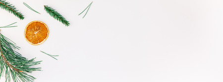 New Year Christmas pattern flat lay top view Xmas holiday handmade handicraft texture with fir tree pine branches cones dried oranges white background copy space Long wide bannerの写真素材