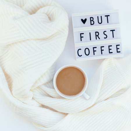 Creative autumn flat lay overhead top view coffee cup vintage lightbox But coffee first text sweater white background copy space minimal style Fall winter season template feminine blog social mediaの写真素材