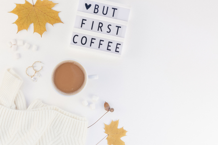Creative autumn flat lay overhead top view coffee cup vintage lightbox But coffee first text sweater white background copy space minimal style Fall winter season template feminine blog social mediaの写真素材