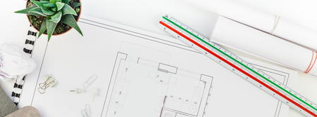 Creative flat lay long wide banner top view blueprints architectural flat project plan office supplies decorator white table workspace with swatches tools and equipment background copy space conceptの写真素材