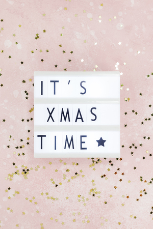 New Year or Christmas composition flat lay top view Xmas holiday celebration handmade handicraft wooden garland with text pink background copy space Template for greeting card text designの写真素材