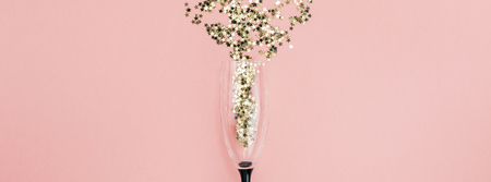 New Year Christmas Top view flat lay champagne glass poured out golden stars confetti copy space millennial pink color paper background minimal style Template feminine blog social media postcardの写真素材