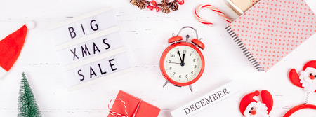 Creative Top view flat lay promotion composition Big Xmas sale text lightbox white wooden background...