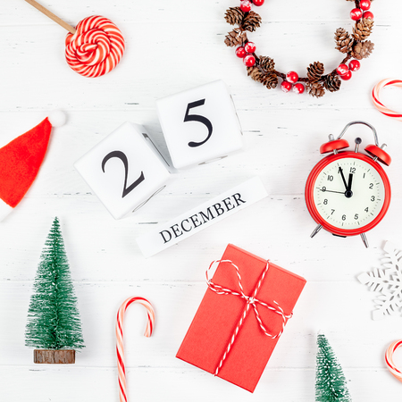 New Year or Christmas pattern flat lay top view red alarm clock twelve midnight Xmas holiday celebration white wooden handmade calendar background. Template for your text design 2019の写真素材
