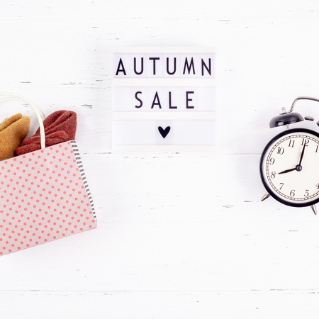 Creative Top view flat lay promotion composition Autumn sale text on lightbox white background copy space Template Autumn sale mockup fall seasonal offer promotion advertising with alarm clock