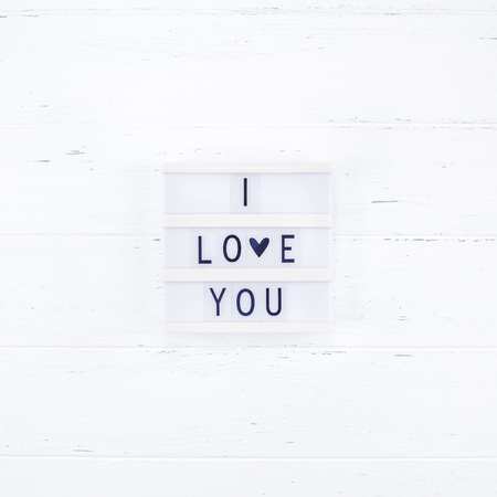 Creative Valentine Day romantic composition flat lay top view love holiday celebration with red heart lightbox white wooden background copy space Template greeting card text design social media blogsの写真素材