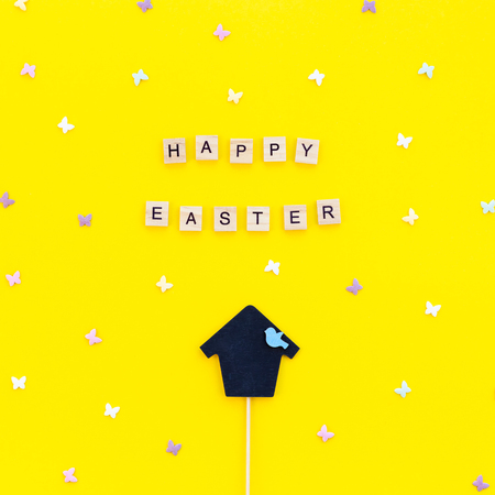 Creative Top view flat lay holiday composition Easter bunny ears eggs text message on bold yellow paper background copy space Template Easter day seasonal minimal concept patternの写真素材