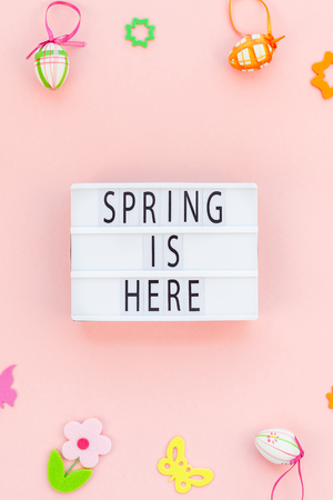 Creative Top view flat lay holiday composition Easter text Spring is here on lightbox pink paper background copy space Template Easter day seasonal patternの写真素材