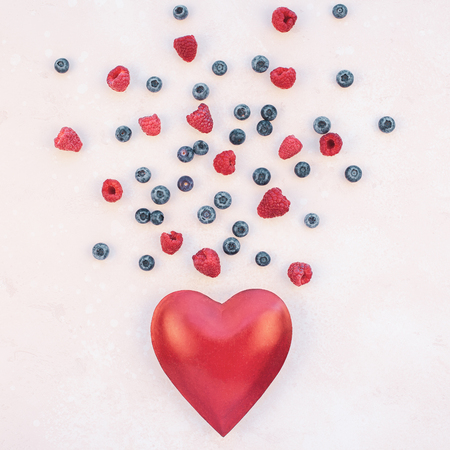 Creative Valentine Day romantic concept composition flat lay top view love holiday celebration red heart raspberry blueberry pink background copy space Template greeting card text social media blogsの写真素材