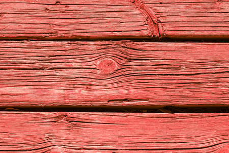 Old weathered wooden plank background painted in living coral, wooden texture wall backgroundの写真素材
