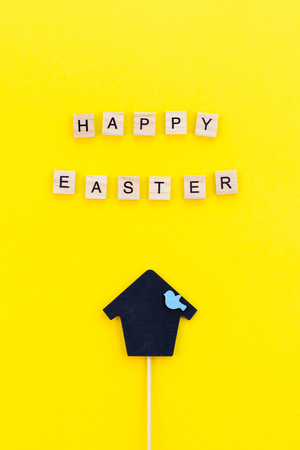 Creative Top view flat lay holiday composition Easter bunny ears eggs text message on bold yellow paper background copy space Template Easter day seasonal minimal conceptの写真素材