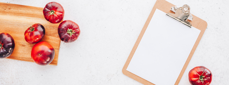 Creative flat lay top view mockup of exotic spanish made tomatoes Mar Azul on white wooden table background copy space. Minimal house cooking concept mock up for blog or recipe bookの写真素材