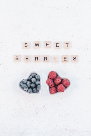 Creative Valentine Day romantic concept composition flat lay top view love holiday celebration red heart raspberry blueberry table background copy space Template greeting card text social media blogsの写真素材