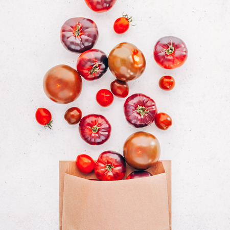 Creative flat lay top view mockup of exotic spanish made tomatoes Mar Azul on white wooden table background copy space. Minimal house cooking concept mock up for blog or recipe bookの写真素材