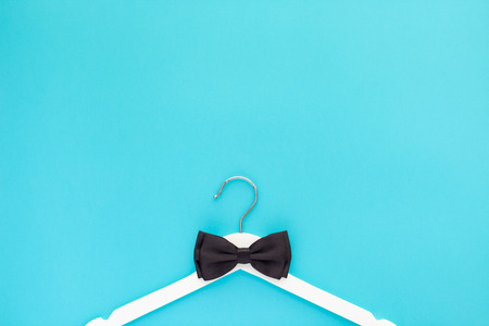 Creative top view flat lay white wooden hangers isolated bold blue turquoise background with copy space minimalism style. Template fashion feminine blog sale store promo design shopping conceptの写真素材