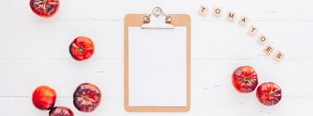 Creative flat lay top view mockup of exotic spanish made tomatoes Mar Azul on white wooden table background copy space. Minimal house cooking concept mock up for blog or recipe bookの写真素材
