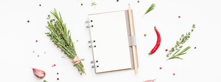 Flat lay overhead view blank notebook pages mockup text space invitation card on white background with greens herbs and spices. Menu or recipe book or food blog design with cooking ingredientsの写真素材