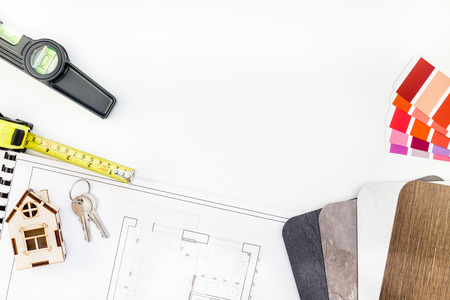 Creative flat lay overhead top view blueprint flat project plan and office supplies on decorator table workspace swatches tools and equipment background copy space conceptの写真素材