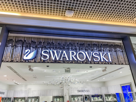 LYON, FRANCE - FEBRUARY 27, 2019: Swarovski store of chain of fashion crystal jewelry accessories stores brand logo, located in Lyon shopping mall France. Mobile photoのeditorial素材
