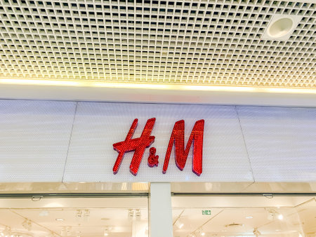 LYON, FRANCE - FEBRUARY 27, 2019: H&M store of international chain of mass fashion retail clothing stores brand logo at its shop located in Lyon shopping mall France. Mobile photoのeditorial素材