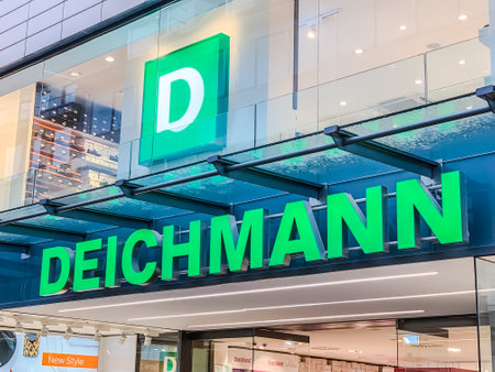 AACHEN, GERMANY - MARCH 01, 2019: Deichmann store of international chain of mass fashion retail footwear stores brand logo at its building located in Aachen shopping street Germany. Mobile photoのeditorial素材