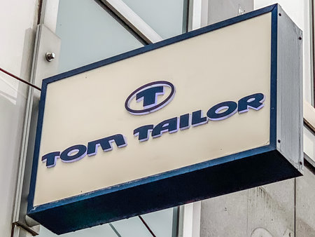 AACHEN, GERMANY - MARCH 01, 2019: Tom Tailor store of international chain of mass fashion clothing retail stores brand logo at its building located in Aachen shopping street Germany. Mobile photoのeditorial素材