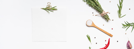 Flat lay overhead view blank recipe paper page with clip mockup text space invitation card on white background with greens herbs and spices. Menu recipe book food blog design with cooking ingredientsの写真素材