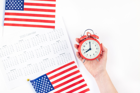 Creative top view flat lay of American flags for Elections, Memorial Day 4th of July or Labour Day with calendar copy space on white background in minimal style. Concept of patriotism and independenceの写真素材