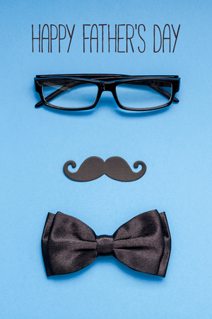 Creative flatlay overhead top view retro black paper photo booth props moustaches blue background copy space. Happy fathers day text concept blog social mediaの写真素材