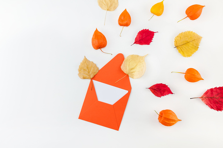 Creative Top view flat lay autumn composition Letter envelope dried orange flowers leaves background copy space Template mockup fall harvest thanksgiving halloween anniversary invitation cardsの写真素材