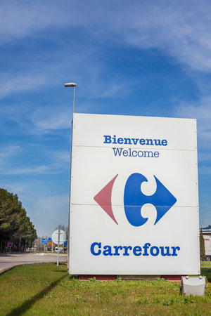 LYON, FRANCE - FEBRUARY 26, 2019: Carrefour company logo on its gas service station in Lyon, France on blue sky backgroundのeditorial素材