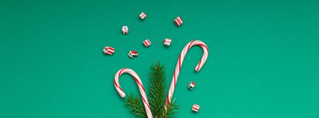 New Year Christmas Xmas holiday party celebration candy canes fir tree branch copy space green color paper wide long banner. Template greeting card 2020の写真素材