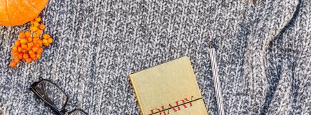 Creative autumn flat lay overhead top view stylish home workspace with notebook coffee cup cozy gray knitted plaid long wide banner copy space. Fall season template feminine blog social mediaの写真素材