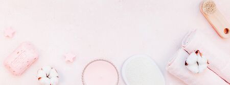 Spa, beauty cosmetics and body care treatment concept with copy space. Creative top view flat lay composition with bath accessories and rose soap cotton flowers, loofah on pink marble table backgroundの写真素材