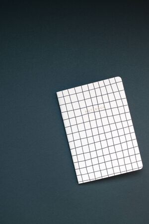 Top view flat lay of pattern notepad with copy space on black color paper background in minimal style. Template for feminine blog social mediaの写真素材