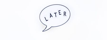 Creative top view flat lay with message Later in bubble lightbox copy space white background minimal style. Concept of procrastination, time management in business and lifeの写真素材