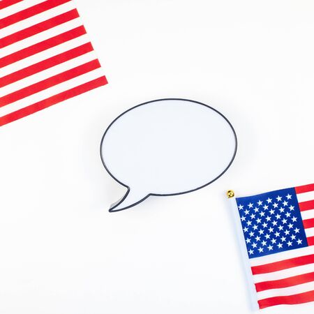 Creative top view flat lay of American flags for Elections, Memorial Day, 4th of July or Labour Day with bubble lightbox mockup with copy space white background. Concept of patriotism and independenceの写真素材
