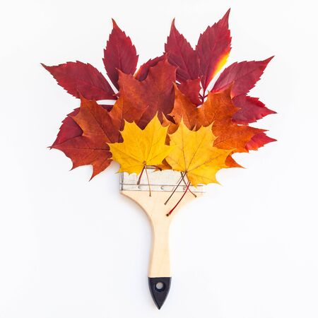 Creative Top view flat lay autumn concept composition. Paint brush dried bright autumn leaves paper background copy space. Square Template mock up fall thanksgiving wedding anniversary invitation cardの写真素材
