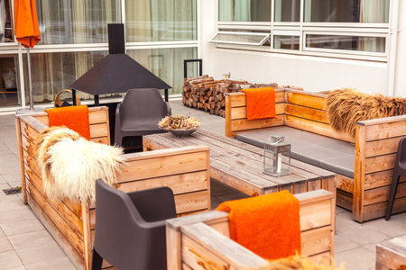 Outdoor restaurant terrace with wooden furniture in scandinavian style. Eco-friendly authentic design.のeditorial素材