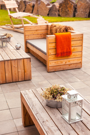 Outdoor restaurant terrace with wooden furniture in scandinavian style. Eco-friendly authentic design.のeditorial素材