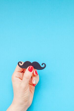 Creative flatlay top view retro black paper photo booth props moustaches woman hands turquoise background copy space. Men health awareness month fathers day masculinity concept blog social mediaの写真素材