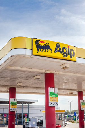 LYON, FRANCE - FEBRUARY 26, 2019: Agip, Italian oil and gas company logo on its gas service station in Lyon, France on blue sky background. In 2003, Eni acquired Agip Petroli S.p.Aのeditorial素材