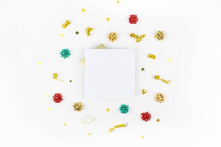 Christmas composition. New Year or Christmas pattern flat lay top view Xmas holiday celebration decorative golden square frame mockup on white background with copy space. Template of greeting cardの写真素材