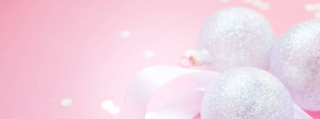 New Year Christmas Xmas holiday celebration composition pearl decorative toy balls green fir branch sparkles confetti pink paper background copy space Template text design Long wide bannerの写真素材