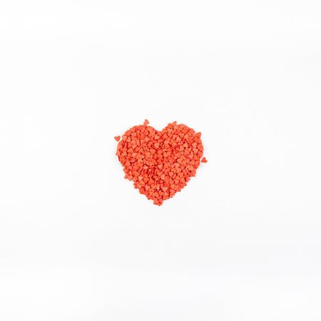Valentine's Day. Creative holiday concept of love made from red heart shaped sweet confetti....