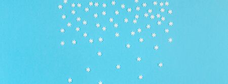 Creative Top view flat lay winter frame. Concept Mockup pattern made of small white snowflakes...