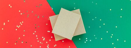 New Year or Christmas presents preparation DIY flat lay top view Xmas holiday celebration handmade gift boxes on red green paper background. Template mockup for greeting card long wide banner 2019の写真素材