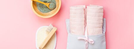 Spa, beauty cosmetics and body care treatment concept copy space. Creative top view flat lay composition bath accessories, green spirulina laminaria cleansing mask in bowl, cup of tea pink backgroundの写真素材