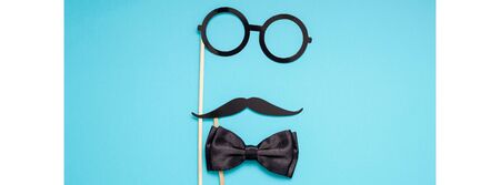 Creative long wide banner top view retro stylish black paper photo booth props moustaches turquoise background copy space. Men health awareness month fathers day masculinity concept blog social mediaの写真素材
